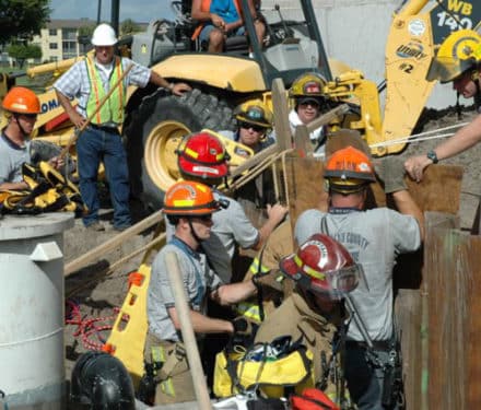 Image of construction workers and firemen after accident
